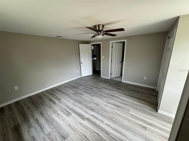 unfurnished bedroom with ceiling fan and light hardwood / wood-style floors