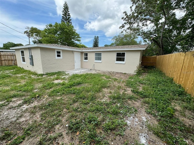 rear view of property with a yard