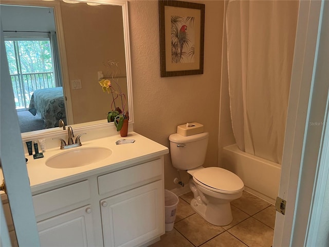 full bathroom with tile patterned flooring, vanity, shower / tub combo, and toilet