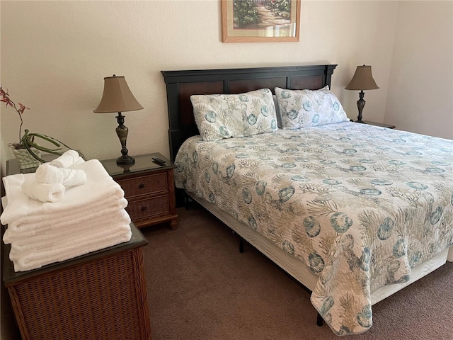 bedroom with dark colored carpet