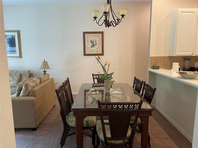 carpeted dining room with a chandelier