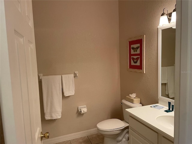 bathroom featuring tile patterned flooring, vanity, and toilet