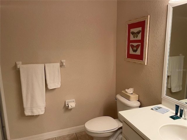 bathroom with tile patterned flooring, vanity, and toilet