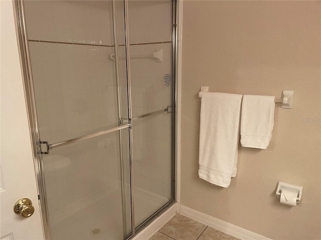 bathroom with tile patterned floors and walk in shower