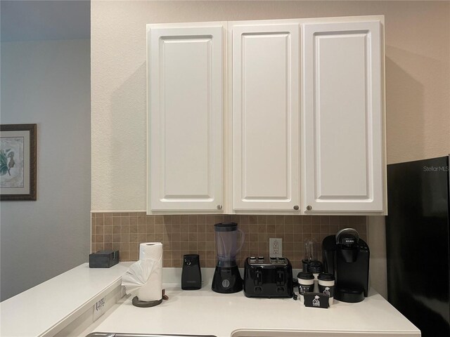 kitchen with white cabinets and backsplash