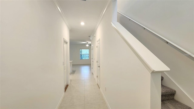 hall featuring ornamental molding and light tile patterned floors