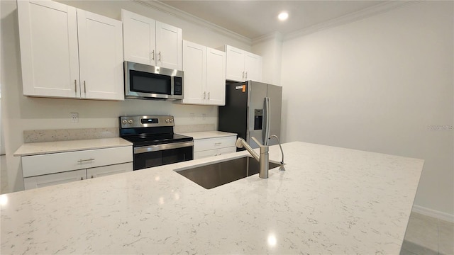 kitchen with stainless steel appliances, sink, white cabinetry, light stone counters, and ornamental molding