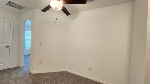 carpeted spare room featuring ceiling fan