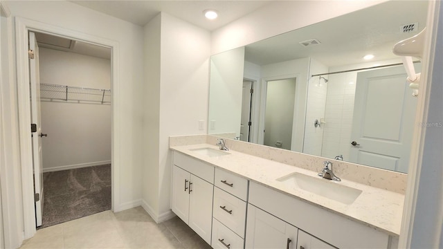 bathroom with tile patterned flooring, an enclosed shower, and vanity