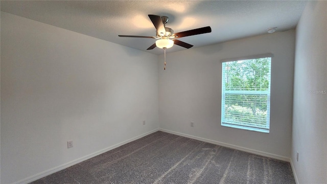 spare room featuring ceiling fan and carpet