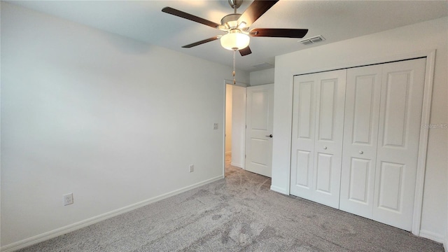 unfurnished bedroom with light carpet, a closet, and ceiling fan