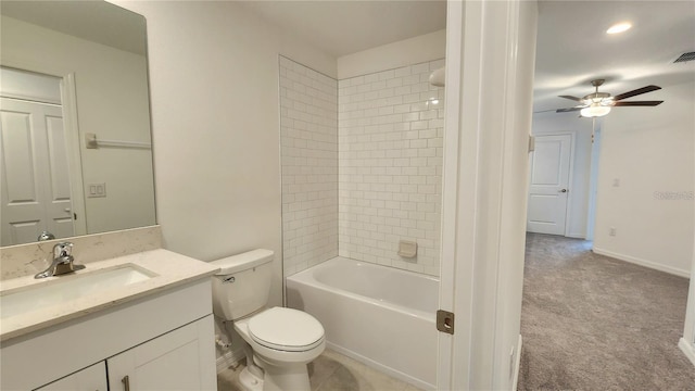 full bathroom featuring toilet, tiled shower / bath, and vanity