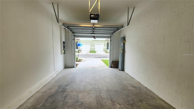 garage with electric panel and a garage door opener