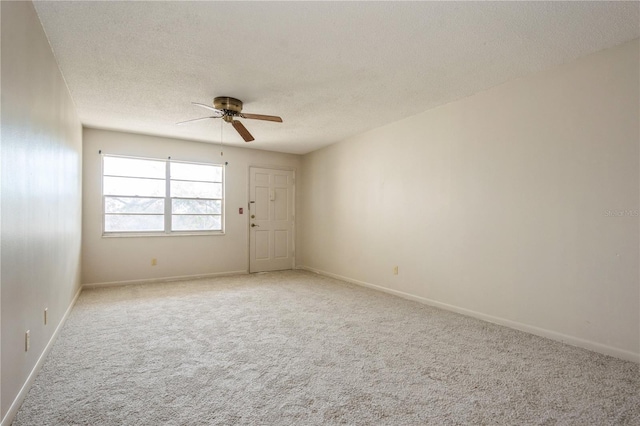 carpeted empty room featuring a textured ceiling and ceiling fan