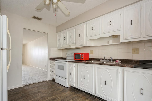 kitchen featuring white appliances, white cabinets, sink, dark hardwood / wood-style floors, and ceiling fan