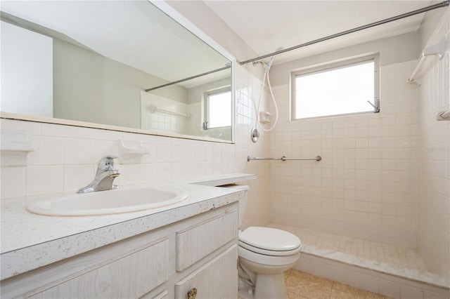 bathroom with tasteful backsplash, tile patterned floors, a tile shower, vanity, and toilet