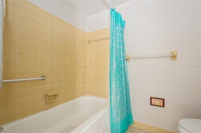 bathroom featuring toilet and shower / bathtub combination with curtain