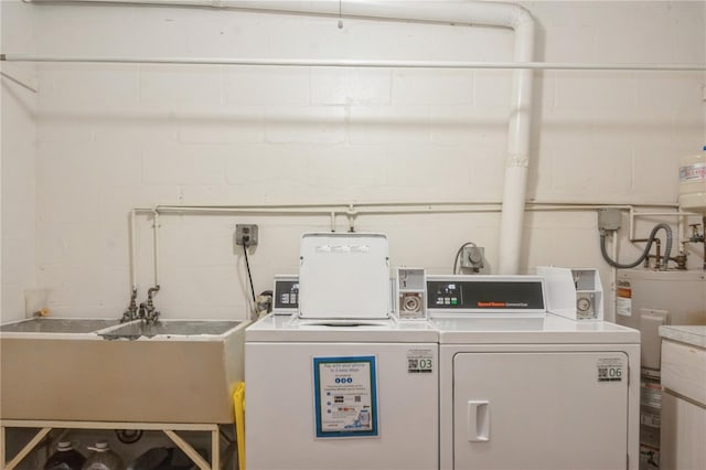 laundry area featuring washing machine and dryer and sink