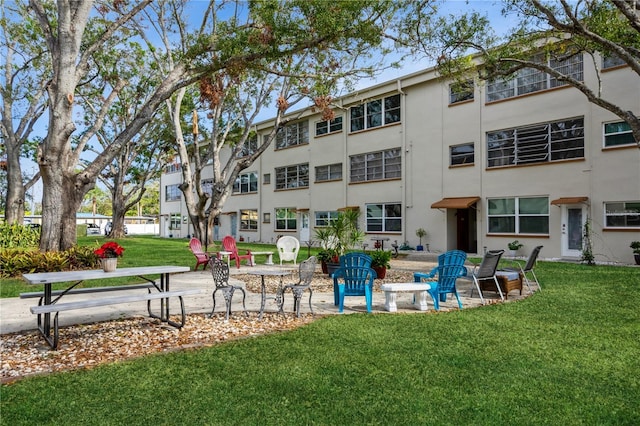 surrounding community featuring a patio area and a yard