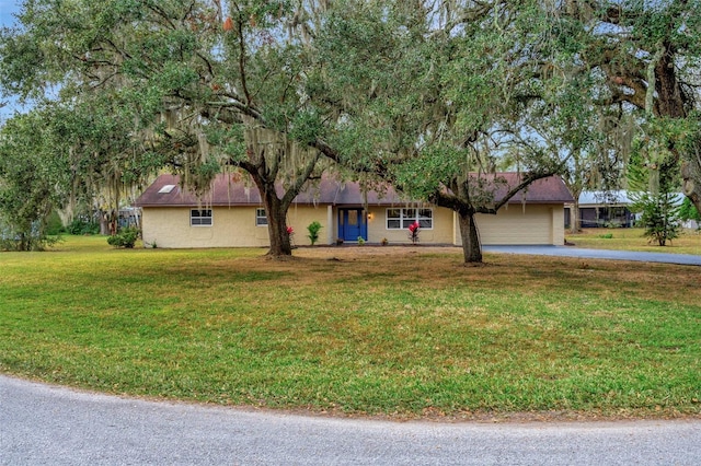 view of front of house with a front yard and a garage