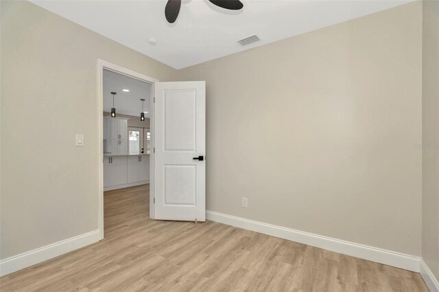 empty room with light wood-type flooring and ceiling fan