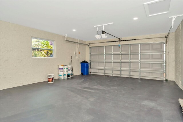 garage with electric panel and a garage door opener