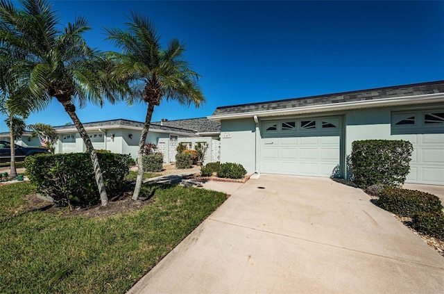 ranch-style house with a garage and a front yard