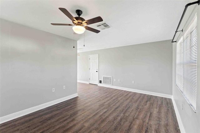 spare room with ceiling fan and dark wood-type flooring