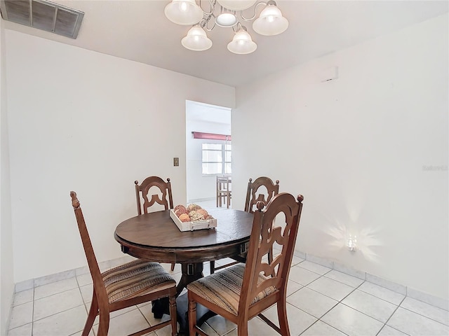 tiled dining space with a notable chandelier