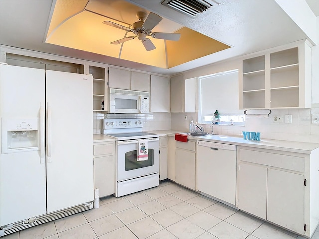 kitchen with backsplash, white cabinets, white appliances, and sink