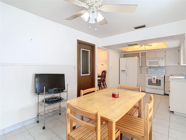 dining room with ceiling fan and light tile patterned flooring