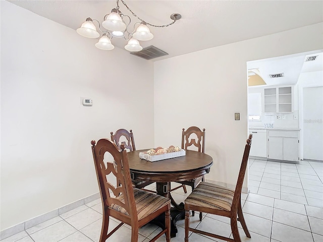 dining room featuring light tile patterned floors and a notable chandelier