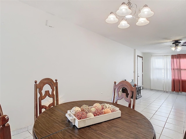 dining room featuring light tile patterned floors and ceiling fan with notable chandelier