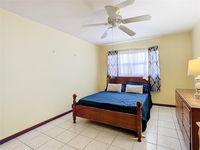 tiled bedroom featuring ceiling fan