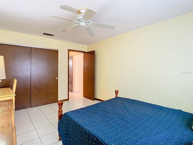 bedroom with ceiling fan, a closet, and light tile patterned floors