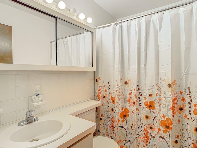 bathroom with vanity, curtained shower, toilet, and backsplash