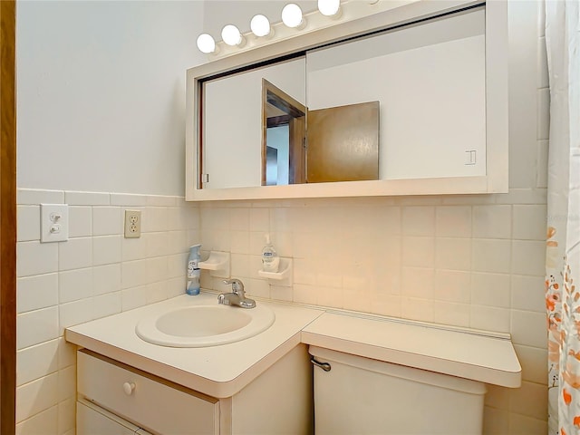 bathroom with vanity, decorative backsplash, and tile walls