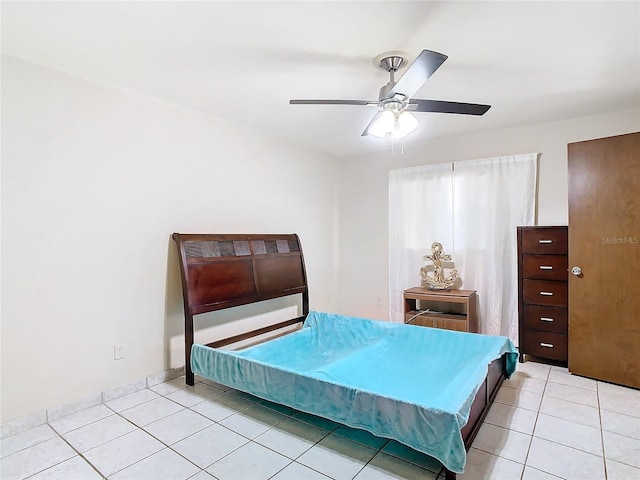 tiled bedroom with ceiling fan