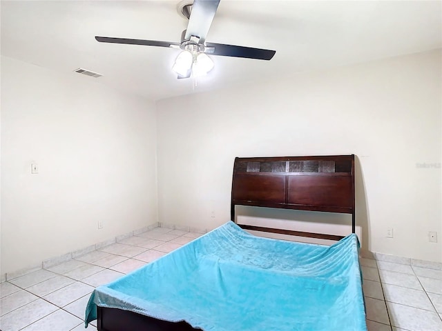 unfurnished bedroom with ceiling fan and light tile patterned floors