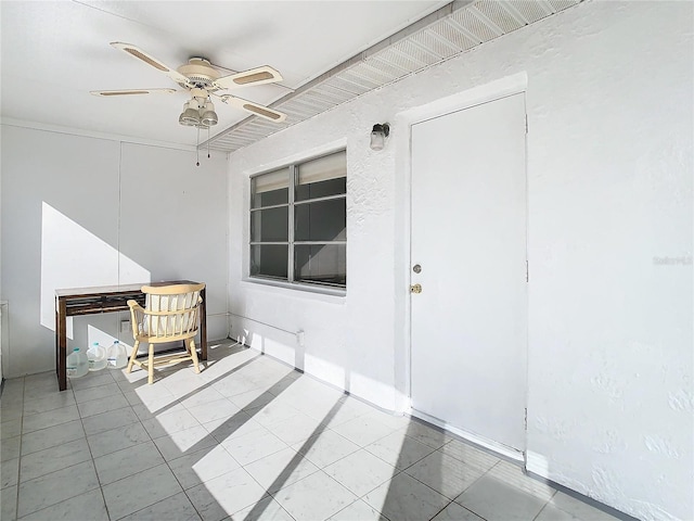 interior space with ceiling fan