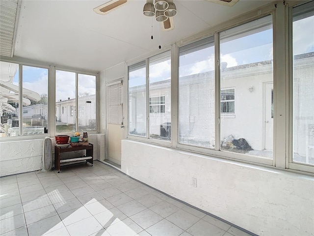 sunroom featuring ceiling fan and plenty of natural light