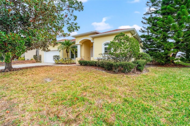 mediterranean / spanish-style home with a garage and a front yard