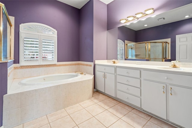 bathroom with tile patterned floors, vanity, and shower with separate bathtub