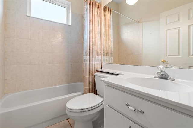 full bathroom featuring tile patterned flooring, vanity, toilet, and shower / bath combo with shower curtain