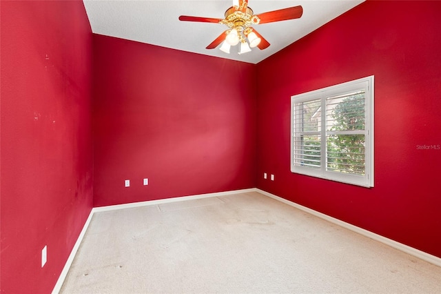 empty room with ceiling fan and carpet