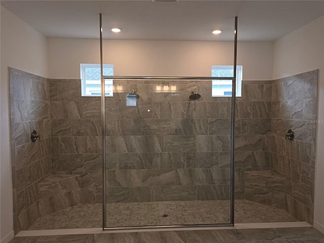 bathroom with tiled shower