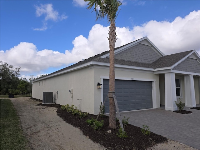 view of home's exterior featuring a garage and central AC unit