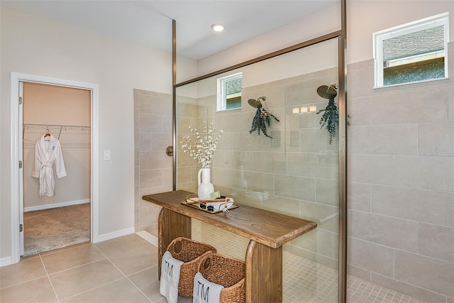 bathroom featuring tile patterned floors and a tile shower