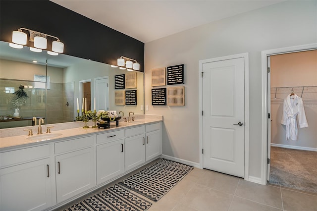 bathroom with tile patterned floors, vanity, and a shower with shower door