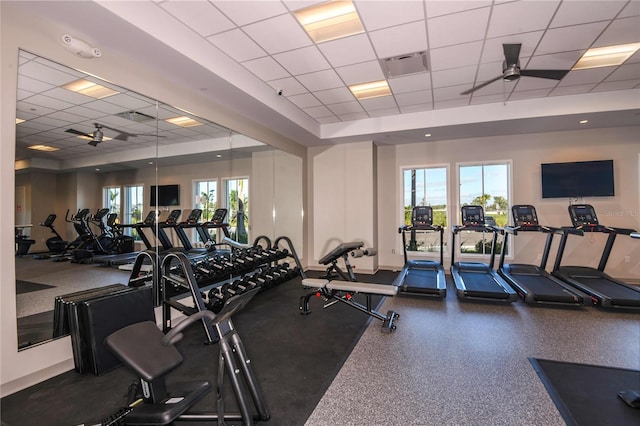 exercise room with a paneled ceiling and a wealth of natural light